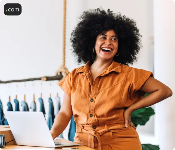 Smiling woman in retail store with hand on hip.